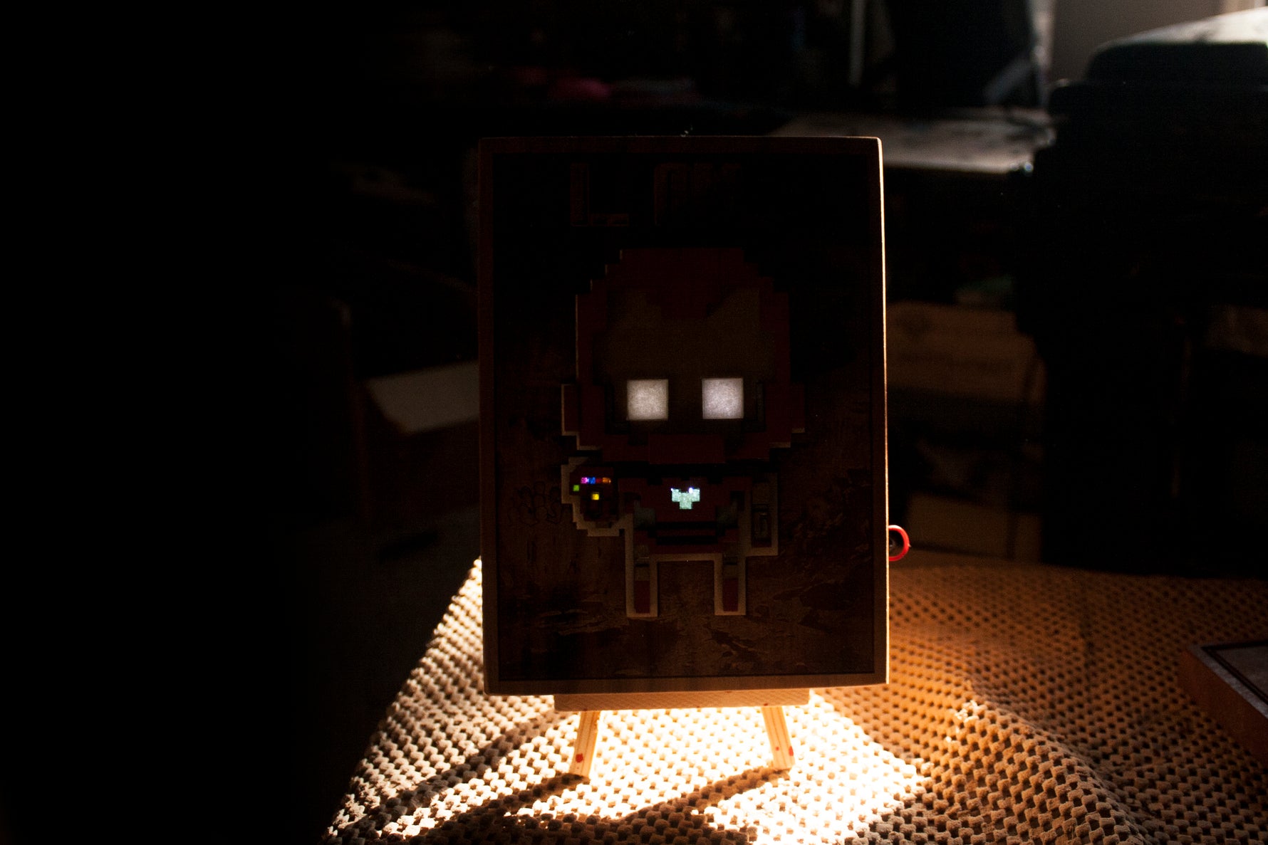 8 bit iron hero with glowing parts, made of wood, resin and acrylic